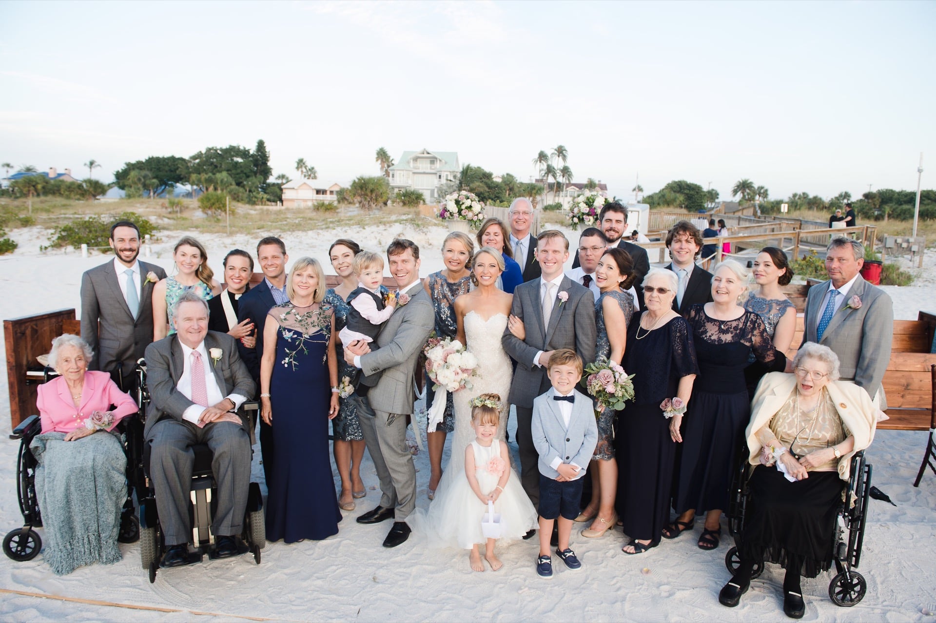 Smiling family at beach side wedding.