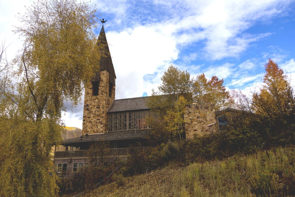 Historic Aspen chapel with brick and glass exterior.